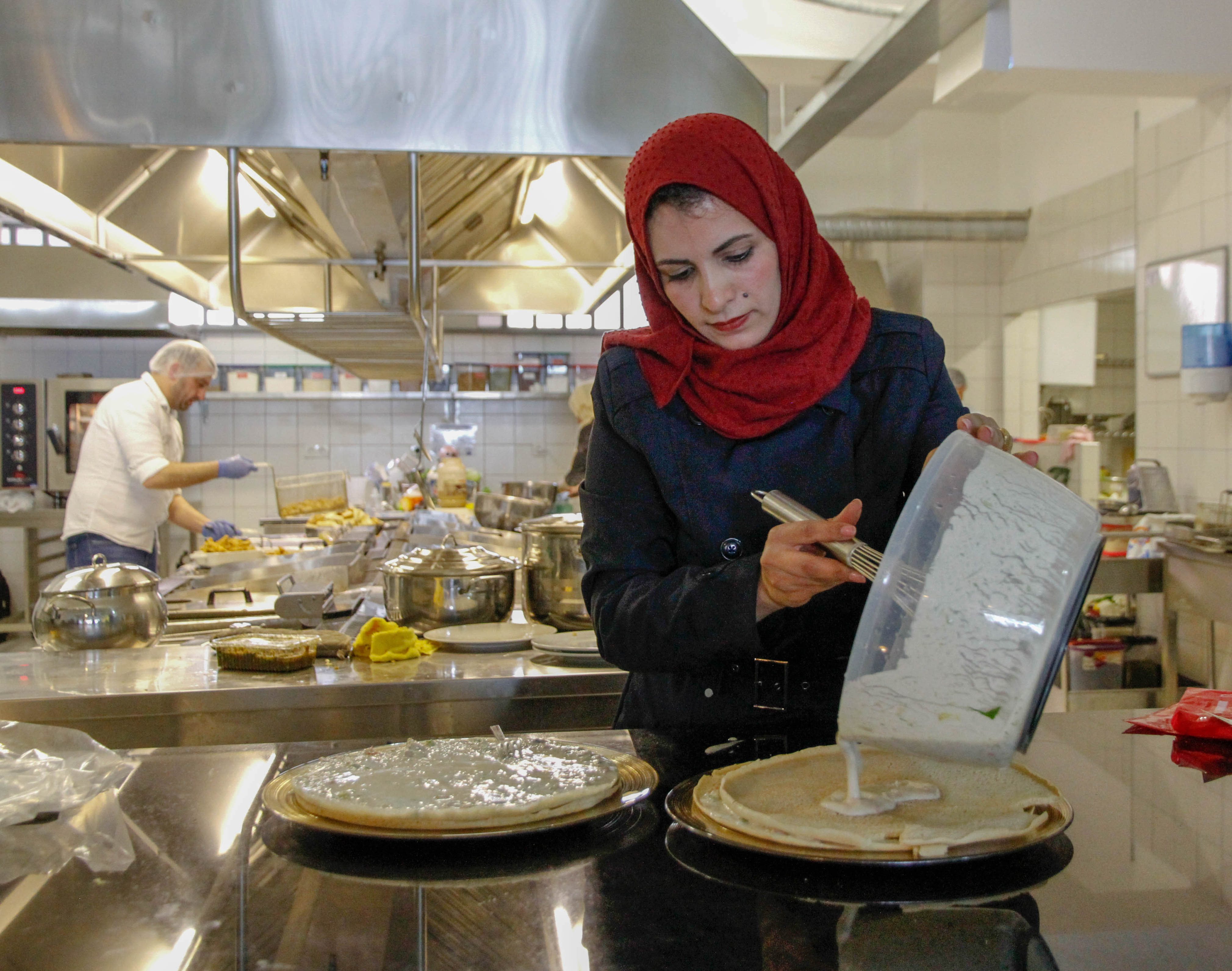 Participant in the LIFE program making food in a commercial kitchen