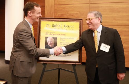 Ross Business School Dean Scott DeRue (left) shakes hands with WDI Board Member Ralph Gerson, for whom the new lecture series honors. 