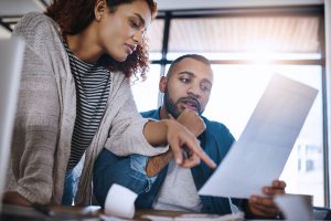 Man and woman looking at paperwork in office setting