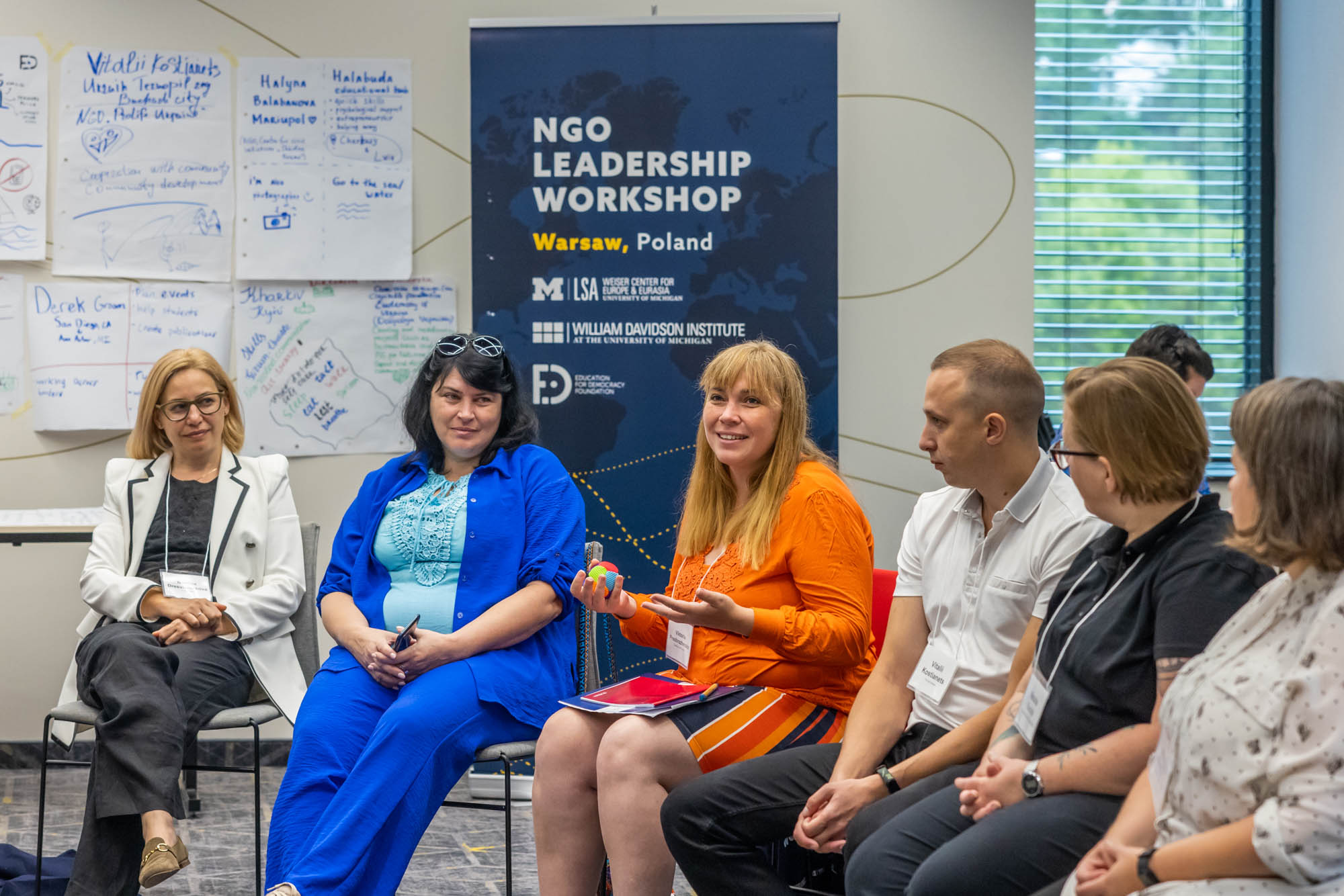 Woman speaking to fellow participants at a session of the NGO leadership workshop