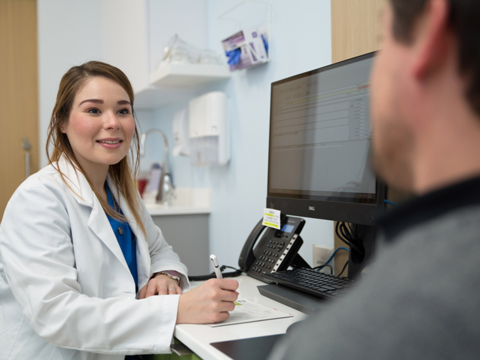 OSMED doctor speaking with patient in clinic