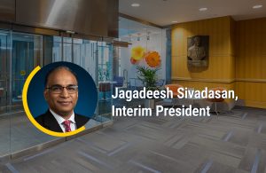 Jagadeesh Sivadasan headshot on top of background image of WDI lobby with the words Jagadeesh Sivadasan, Interim President overlaid.
