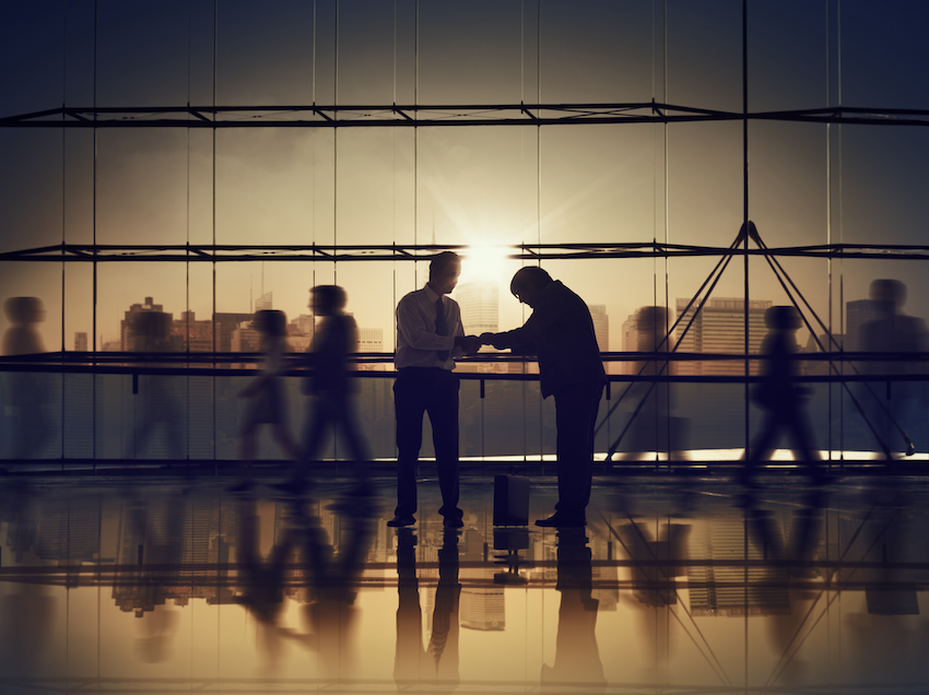 People standing in front of large office window