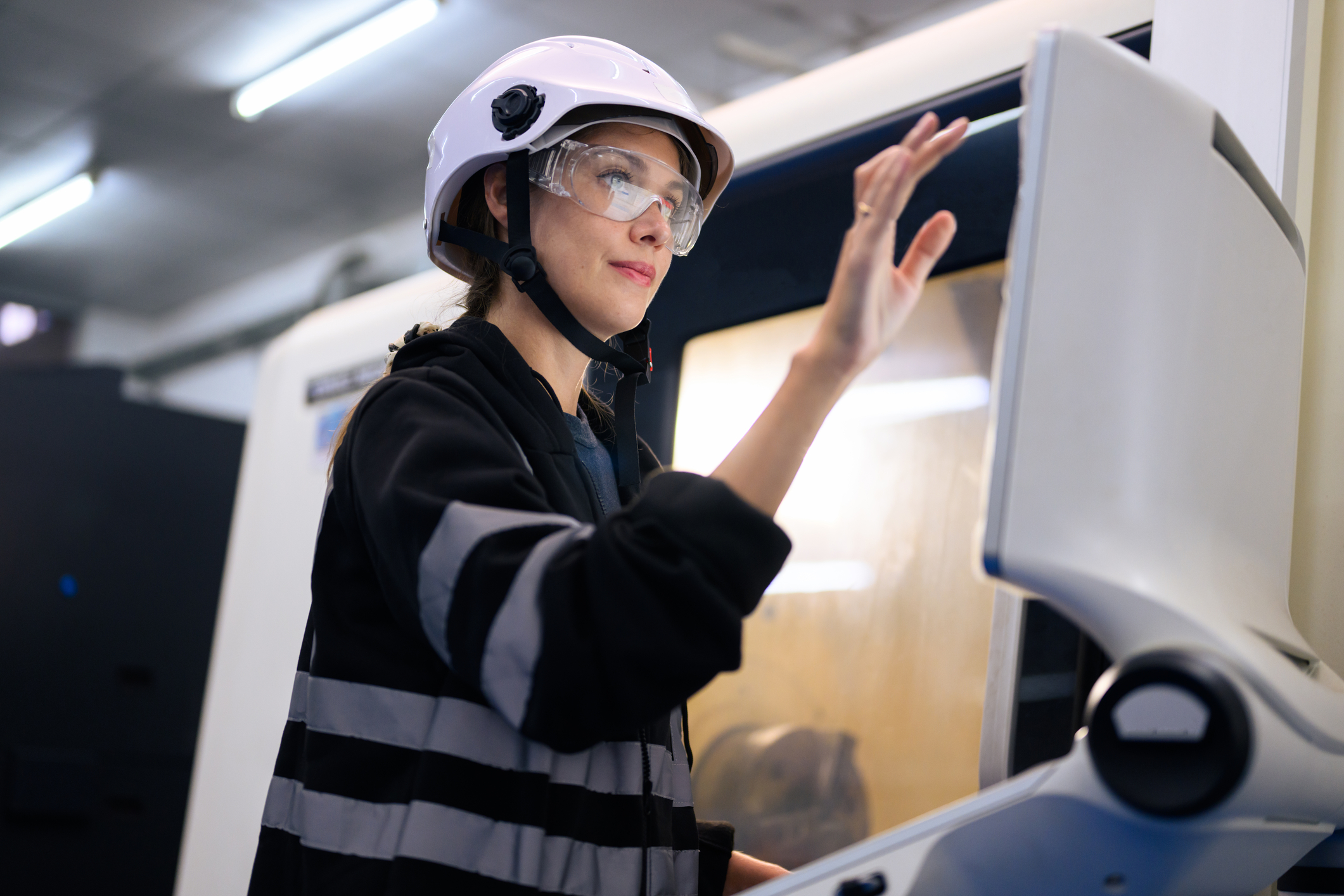 engineer mechanician operating and controlling cnc machine