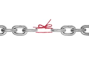 The weak link in the chain -Broken chain with piece of red string holding together, included clipping path