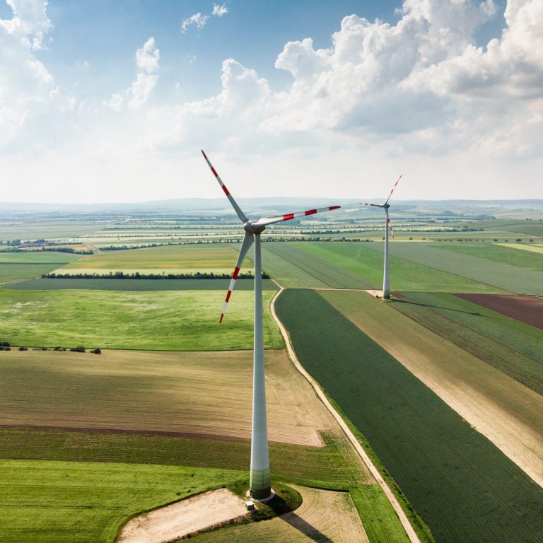 Aerial view of wind turbine in field