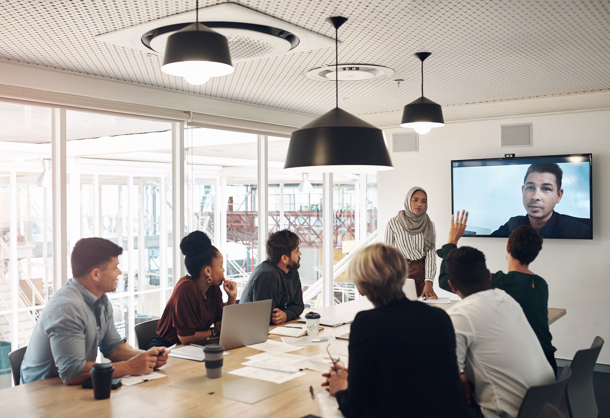 Conference room with diverse group of people sitting at a table