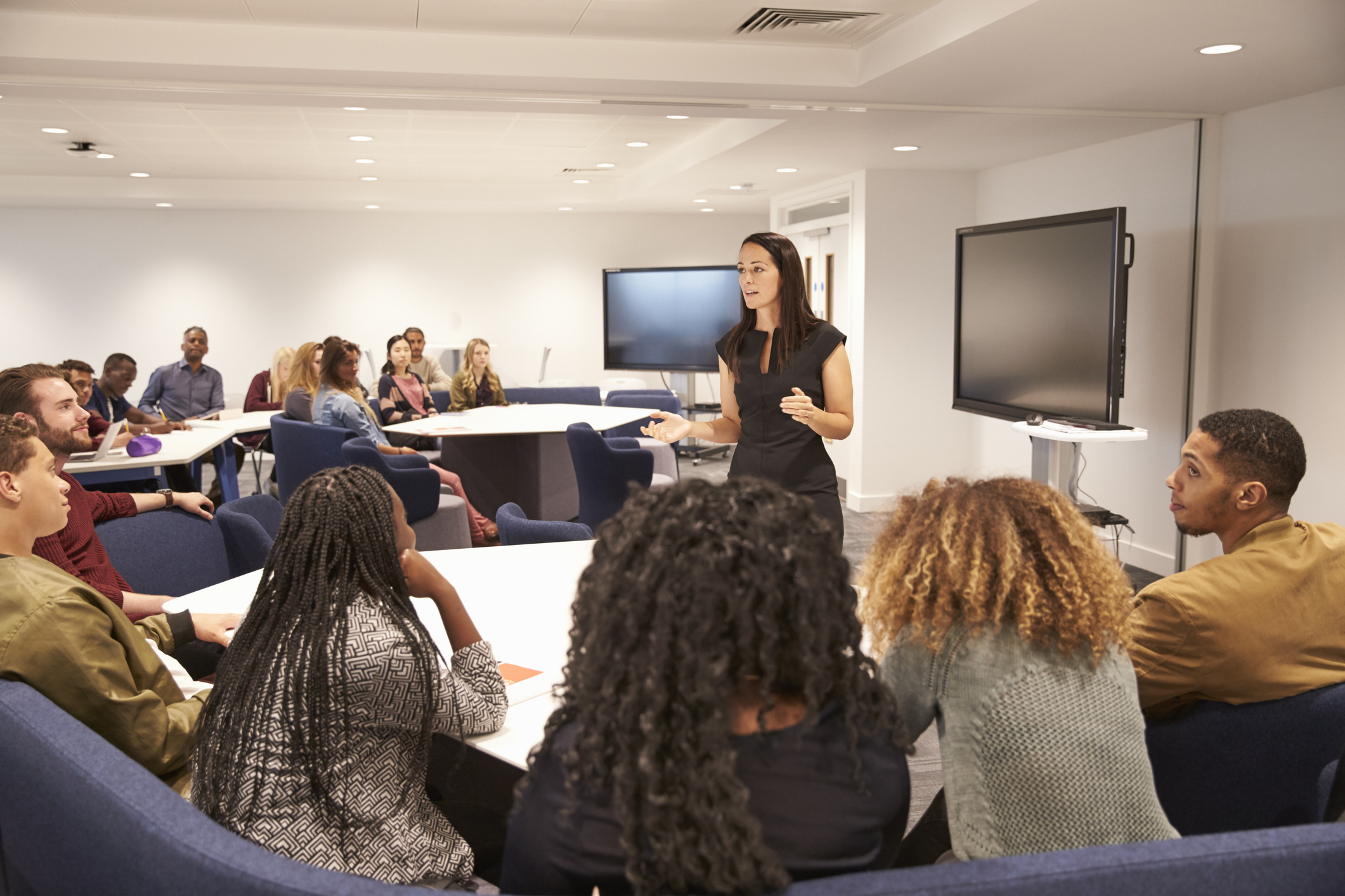 Students in a classroom listening to a speaker