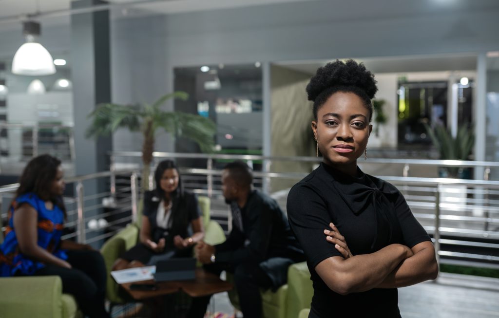 young african businesswoman standing confidently in a modern office